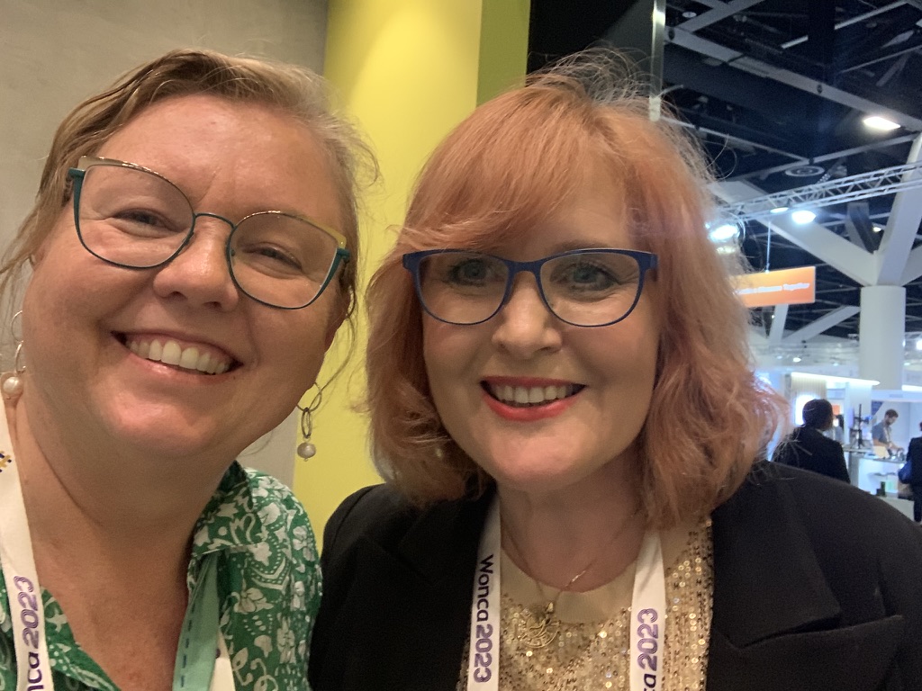 Two delegates wearing WONCA 2023 lanyards at the conference